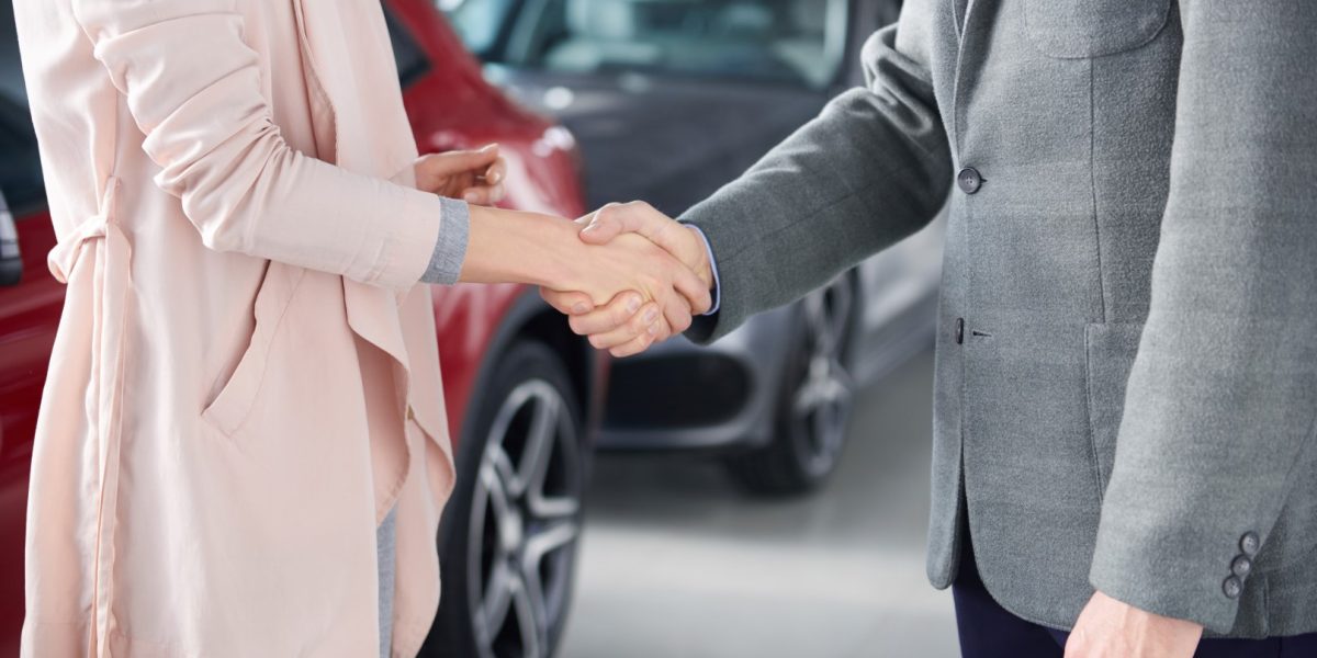 Close up of handshake salesman and woman