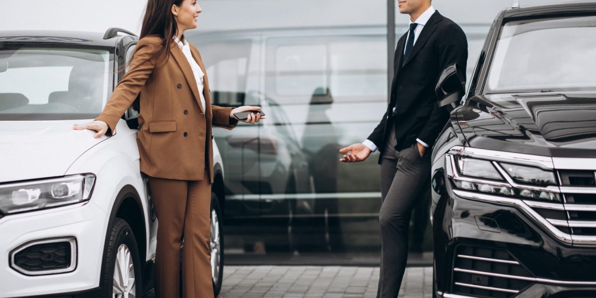 Young couple choosing a car in a car showroom